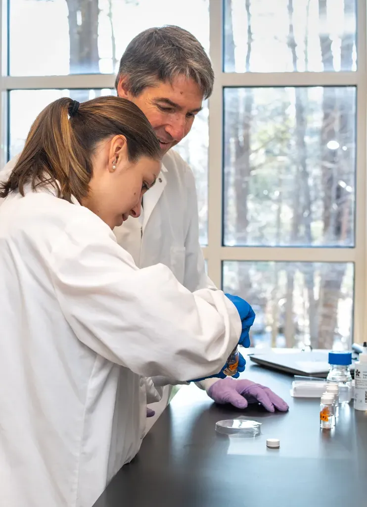 A student works with a professor on research